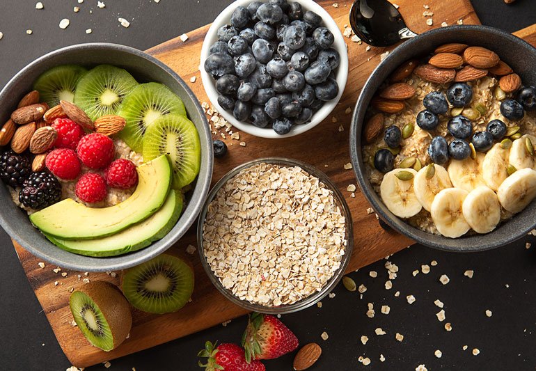 A variety of healthy carbohydrates like oats, rice, and fruits, demonstrating that carbs are not inherently fattening.